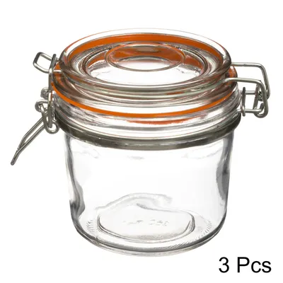 A clear studio shot of a glass jar with a clamp lid.