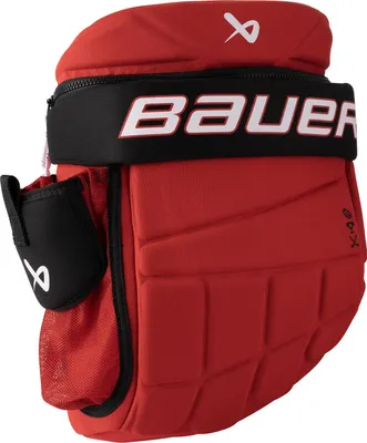 A close-up view of a red and black hockey glove backpack.