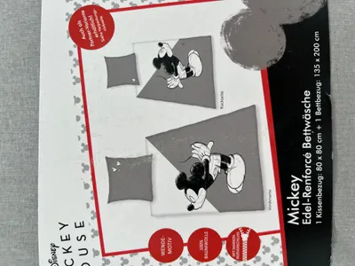 Packaging for a Disney Mickey Mouse bedding set, showing illustrations of the product and text details.