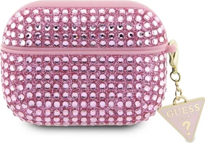 A pink, rhinestone-covered AirPods Pro 2 case with a gold chain and a triangular Guess charm.
