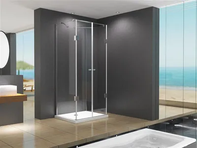 A modern bathroom with a glass shower enclosure overlooking a beach.