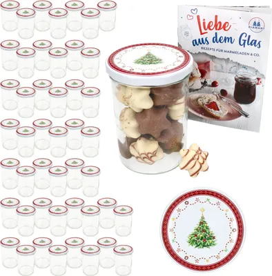 A collection of glass jars, a jar filled with cookies, a recipe book, and a decorative plate, all with a Christmas theme.