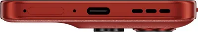A close-up view of the bottom edge of a red smartphone, showing the USB-C port and speaker grilles.
