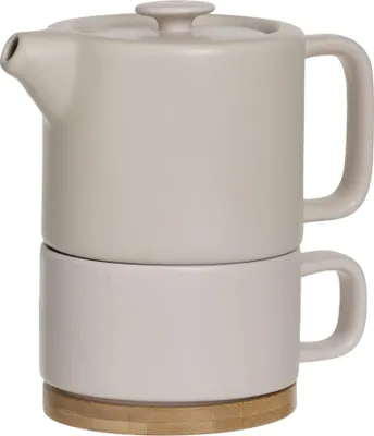 A stacked teapot and cup set on a wooden base.