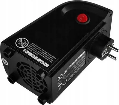 A black portable mini heater is shown plugged into a wall socket.