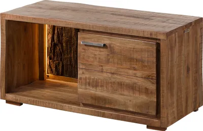 A wooden cabinet with a drawer and an open shelf with a natural bark insert illuminated by interior lighting.