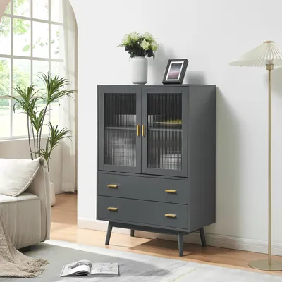A dark gray cabinet with glass doors and gold handles is shown in a room with a couch and a floor lamp.