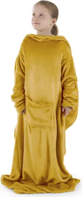 A young girl wearing a yellow blanket with sleeves.