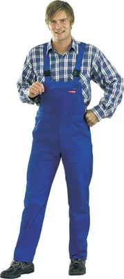 A man wearing blue overalls and a plaid shirt stands against a white background.