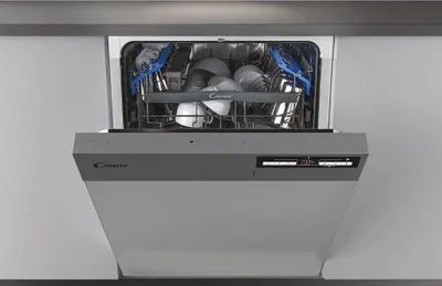 An open dishwasher with dishes inside, set into a kitchen counter.