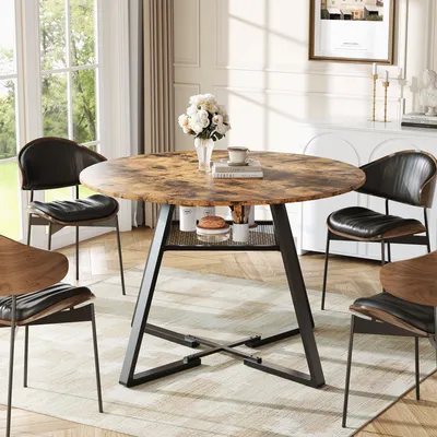 A round dining table with chairs in a dining room setting.