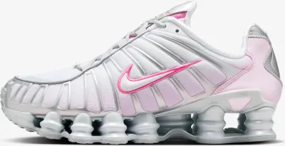 A side view of a Nike Shox TL sneaker in white, pink, and silver.