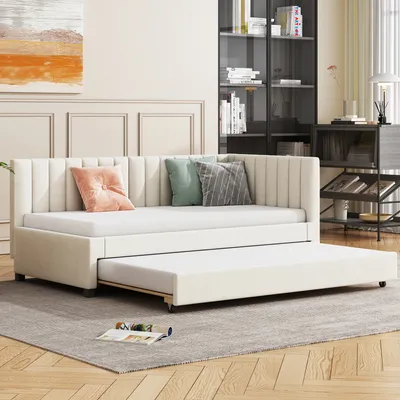 A beige daybed with an extended trundle bed is shown in a living room setting.