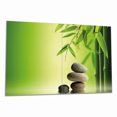 Produktbild von Wallario Herdabdeckplatte aus Glas, Größe 80 x 52 cm 2-teilig, Motiv Steinstapel im Grünen
