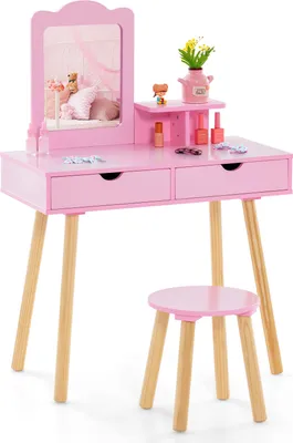 A pink children's vanity table and stool set with a mirror and accessories.