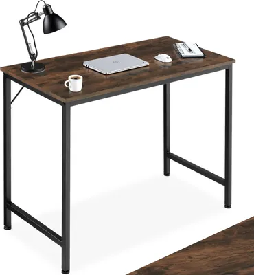A desk with a laptop, mouse, notebook, and coffee cup on it.