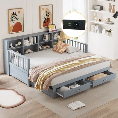 A daybed with storage drawers and a bookshelf headboard, set in a bedroom with artwork on the wall and a bookshelf in the background.