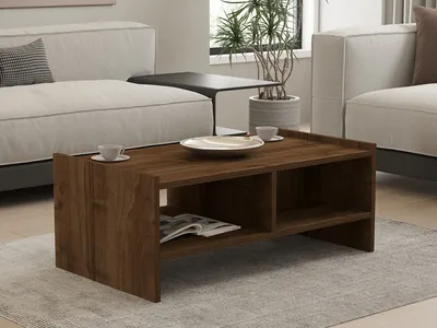 A living room scene with a couch, coffee table, and plant.