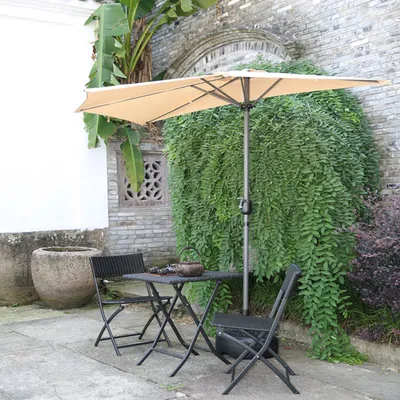 An outdoor patio scene with a table and chairs under a large umbrella.