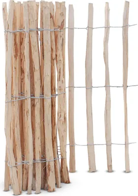 A close-up view of a wooden picket fence made of hazelnut branches, held together by wire.