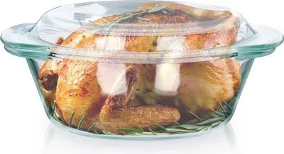 A roasted chicken in a glass baking dish with a lid.