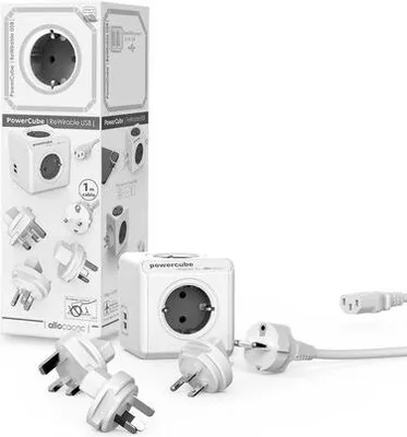 A product shot of a PowerCube travel adapter and its accessories, including various plugs and a cable, arranged on a white background.