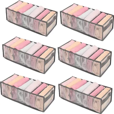 Six identical fabric drawer organizers filled with neatly folded clothing, arranged in two rows of three.