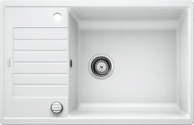 A top-down view of a white kitchen sink with a drain and a ribbed draining board.
