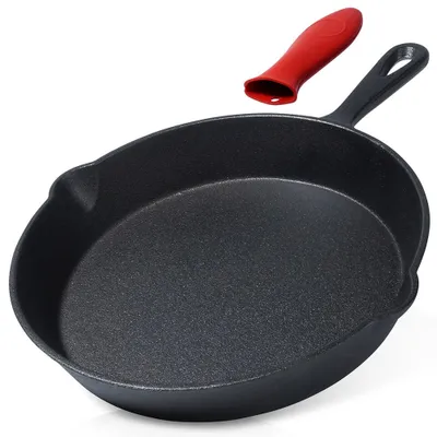 A black cast iron skillet with a red silicone handle cover is shown against a white background.
