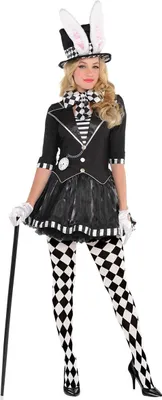 A woman wearing a Mad Hatter-inspired costume, including a top hat with bunny ears, a checkered bow tie, a black jacket with a ruffled skirt, and diamond-patterned tights.