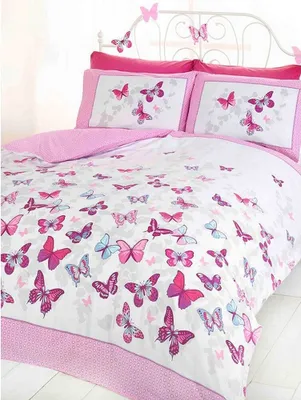 A close-up view of a butterfly-themed bedding set on a bed.