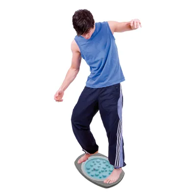 A young man is balancing on a balance board.