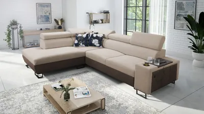 A modern living room with a sectional sofa, coffee table, and decorative elements.