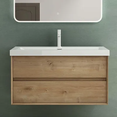 A bathroom vanity with a sink and faucet against a green wall.