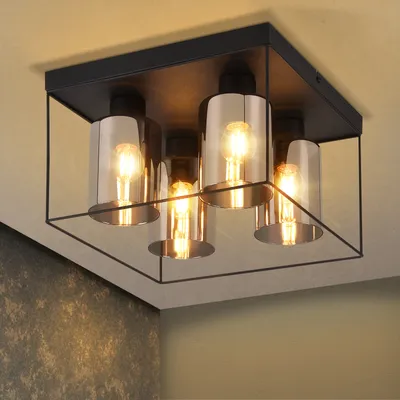 A modern ceiling light fixture with four glass shades and a black metal frame, mounted on a ceiling.