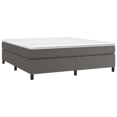 A grey bed frame with a white mattress on a white background.