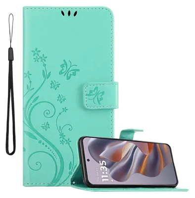 A turquoise flip phone case with a floral and butterfly design is shown open, with a smartphone inside. A wrist strap is attached to the side.