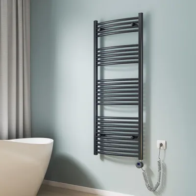 A bathroom setting with a towel radiator, bathtub, and curtain.