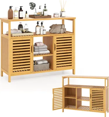 A bamboo bathroom cabinet with slatted doors and open shelves, displaying towels and toiletries.
