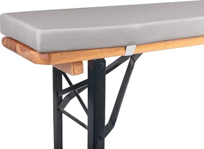 A close-up view of a bench cushion on a wooden and metal bench.
