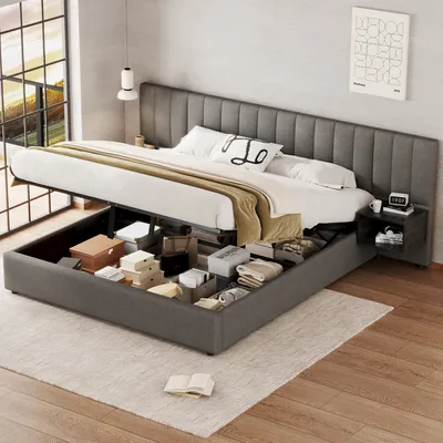 A bed with its storage compartment open, revealing various items stored inside. The bed is in a bedroom setting with a window and a nightstand.