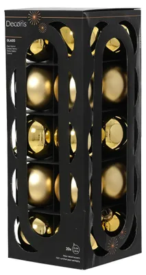 Eine schwarze Kartonverpackung mit Sichtfenstern, gefüllt mit zwanzig goldenen Christbaumkugeln aus Glas in matten und glänzenden Varianten.