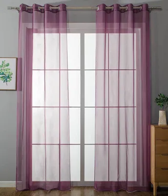 A window with purple sheer curtains.