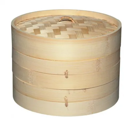 A bamboo steamer basket with multiple tiers and a woven lid.