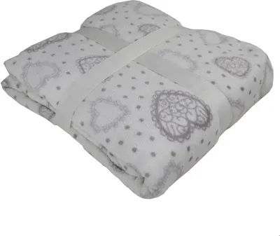 A folded blanket with a heart pattern.