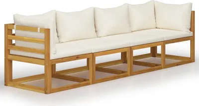 A long, four-seater outdoor sofa made of light-colored wood with cream-colored cushions, shown from a side-front angle against a white background.