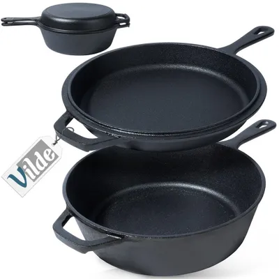 A stack of cast iron cookware, including a lidded pot and two frying pans, on a white background.