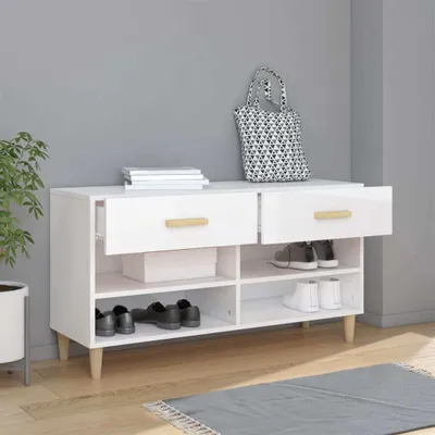 A white shoe cabinet with drawers and shelves, placed against a light gray wall.