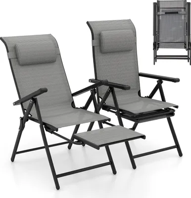 Two gray folding lounge chairs with headrests and a pull-out footrest are shown against a white background. A folded chair is visible in the upper right corner.