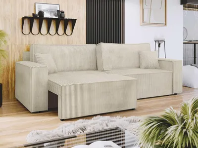 A cream-colored sectional sofa in a living room setting with wood-paneled walls and a fluffy rug in front.